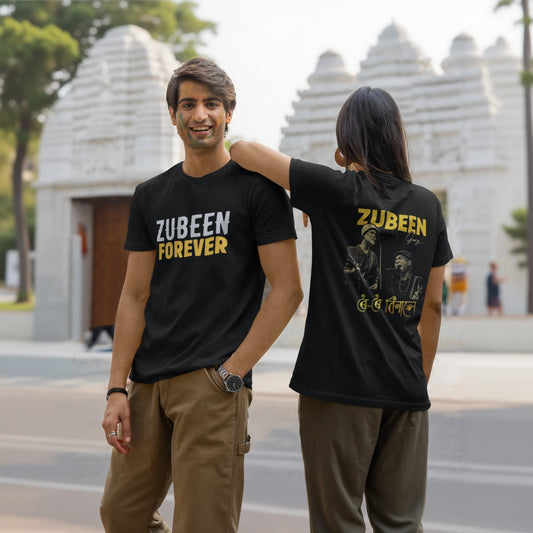 Two people wearing black t-shirts with 'Zubeen Forever' text, one with a graphic on the back, in front of a temple.